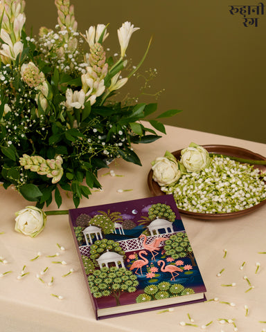 Decorative planner 2026 with flamingo design on a table with flowers and greenery
