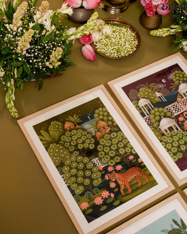Framed illustrations of nature scenes with animals on a green surface.