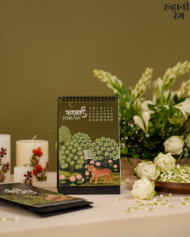 Desk calendar with a tiger design on a table with flowers and candles