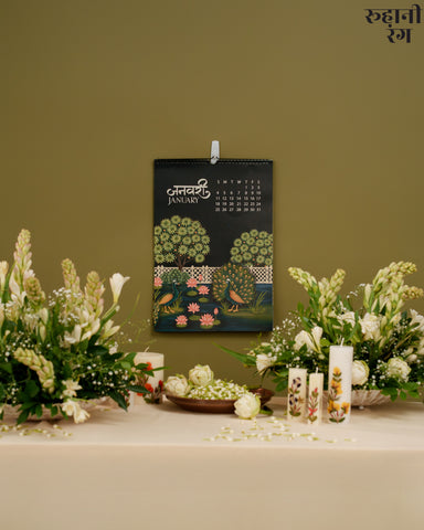 Hand-painted calendar page showing peacocks by a lotus pond, inspired by Vrindavan and Pichola, blending art and calm into everyday décor.